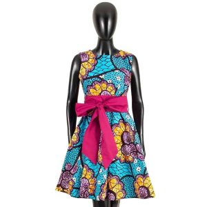 African dress featuring vibrant blue, yellow, and pink floral patterns with a pink bow, displayed on a mannequin.