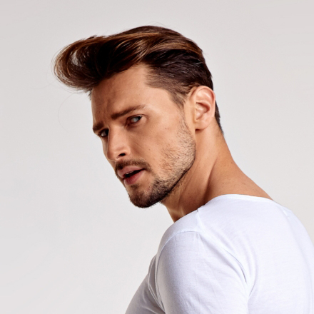 Man with stylish haircut and casual attire, showcasing a modern hairstyle suitable for a casual look, relevant to La Belle African Braids' portfolio.