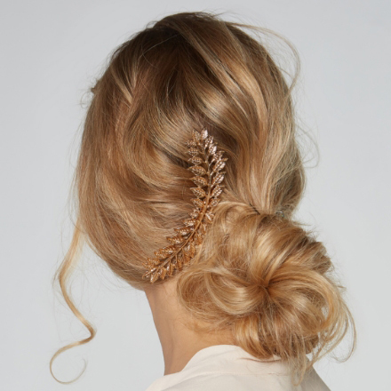 Elegant casual hairstyle featuring a low bun adorned with a decorative hairpiece, showcasing a stylish and sophisticated look for clients of La Belle African Braids.